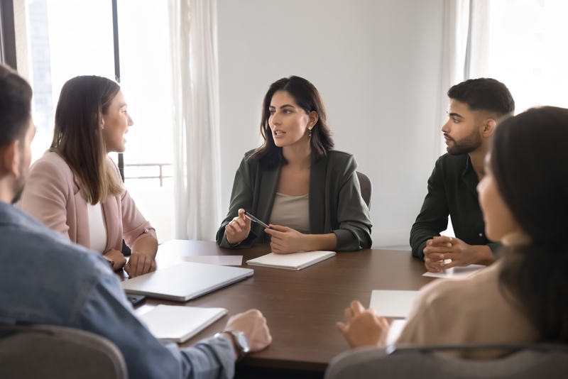 Professionals_seated_around_conference_table